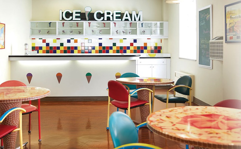 A vibrant ice cream shop interior with colorful tiled walls and stylish furniture.