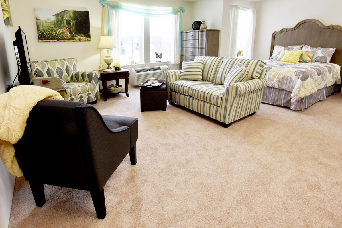 A cozy living room with striped furniture and natural light.