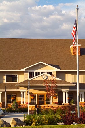 A welcoming residential building featuring a front entrance and an American flag.