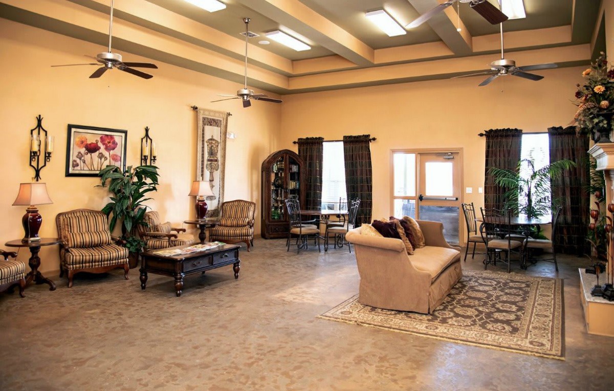 A spacious and elegantly decorated living room with comfortable seating and large windows.