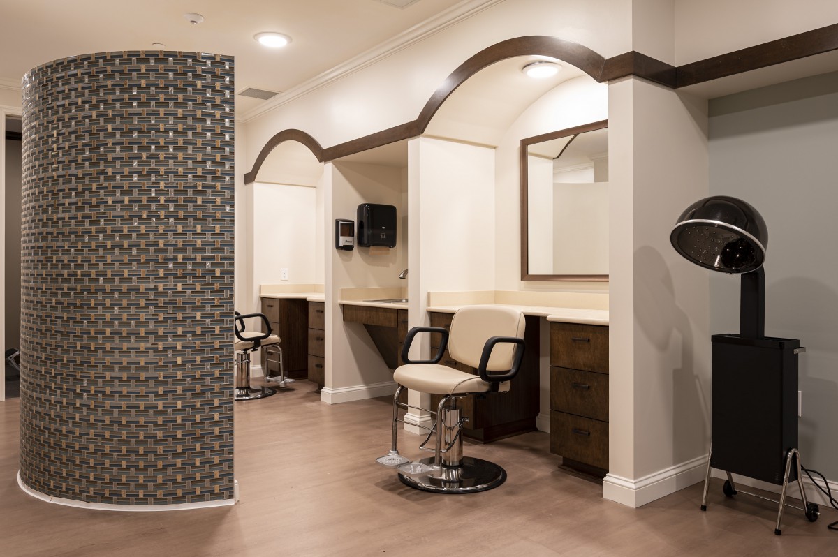 A modern hair salon interior with styling stations and mirrors.