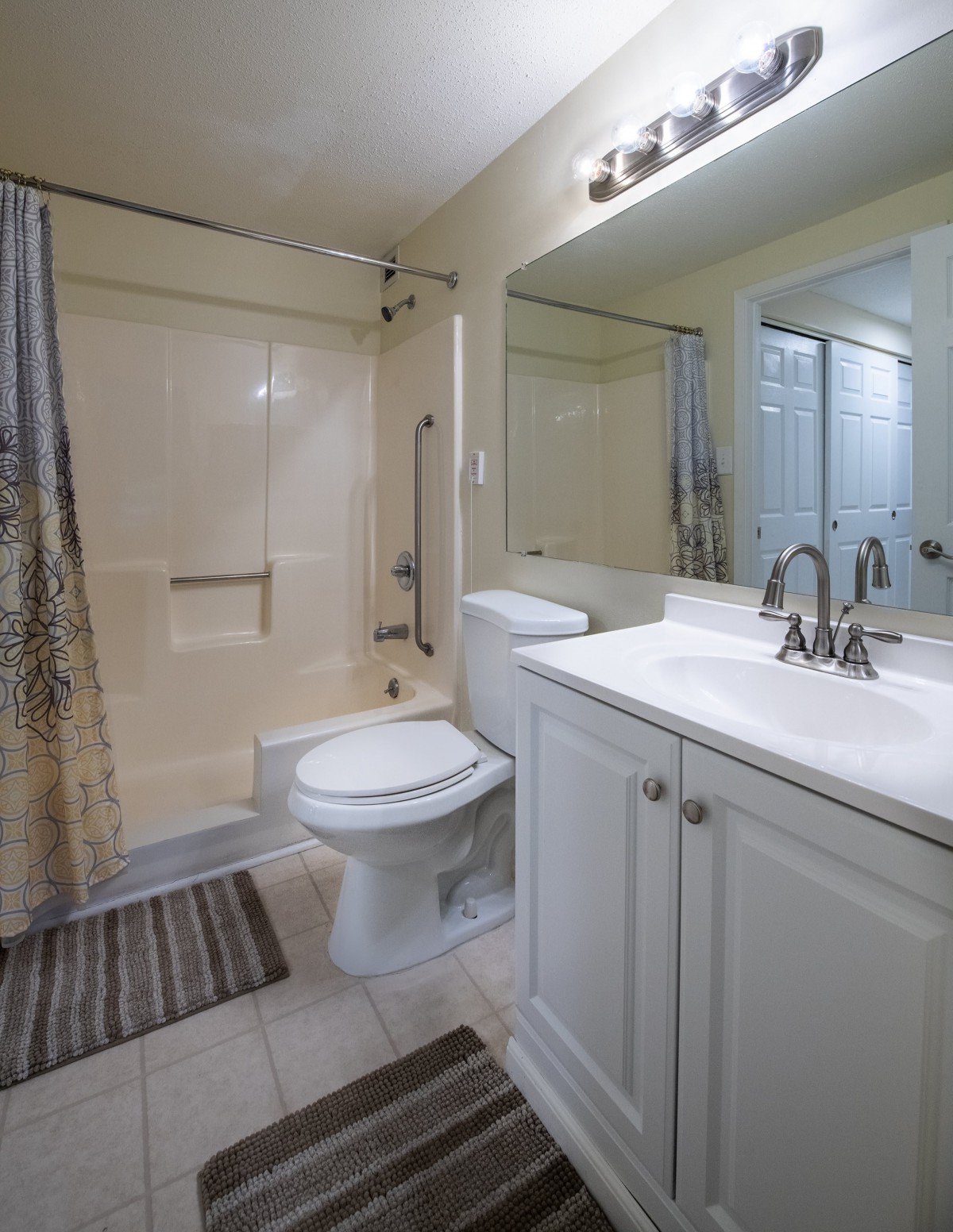 A modern bathroom with a sink, toilet, and shower area.
