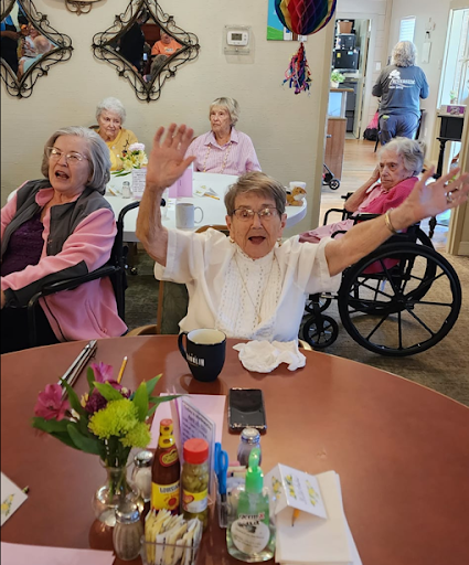 A joyful moment among residents at a care facility, celebrating life and companionship.