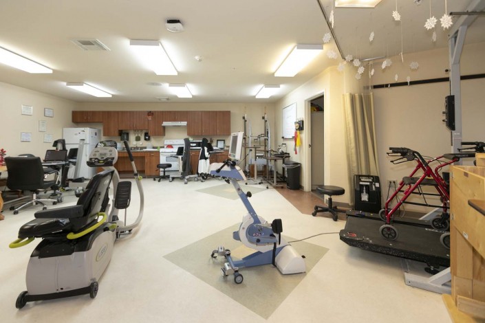 A rehabilitation center equipped with various exercise machines and therapy equipment.