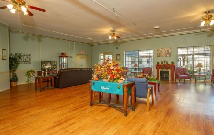 Spacious living room with elegant furniture and floral decor.