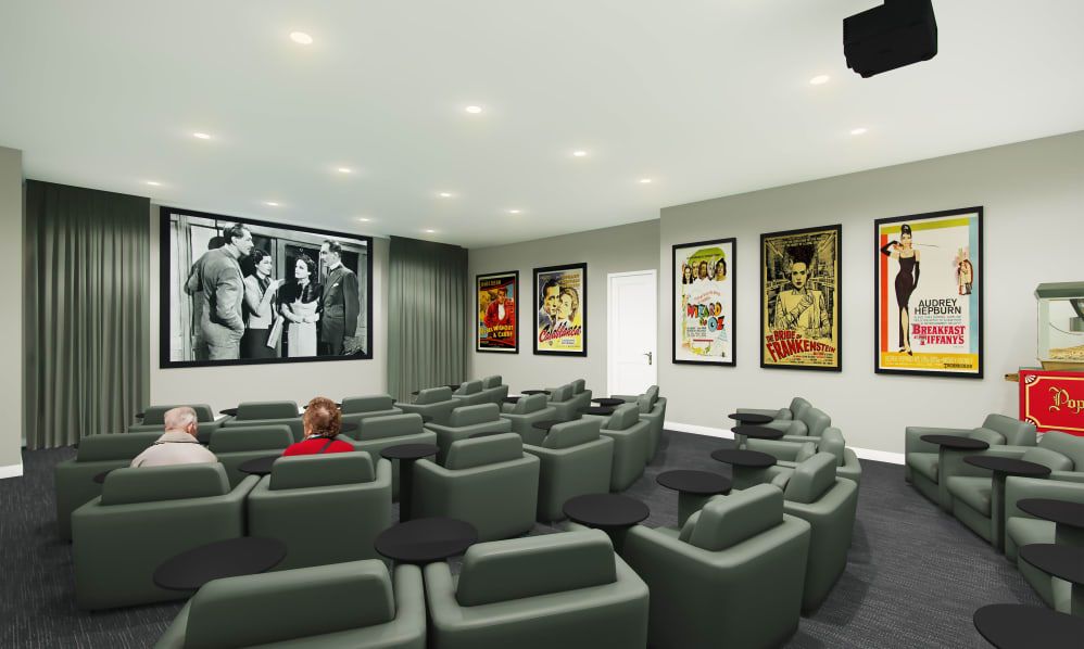 A stylish home theater room featuring comfortable seating and classic movie posters.