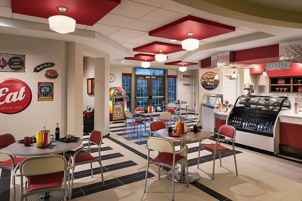 A retro-themed diner with vintage decor and classic red and white furniture.