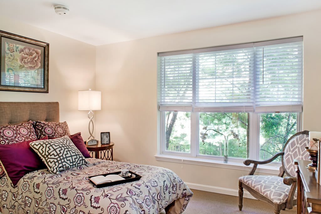 A cozy bedroom with elegant decor and ample natural light.