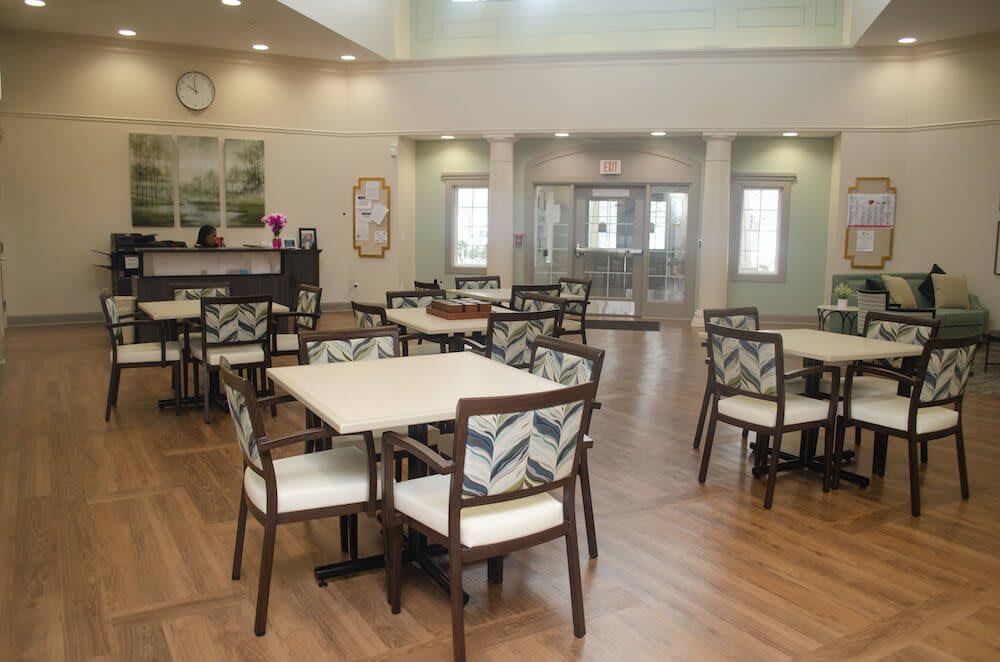 A modern dining area with neatly arranged tables and chairs, featuring a bright and spacious interior.