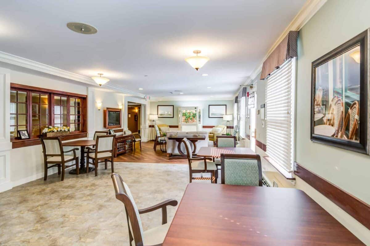 A spacious and well-lit dining area with multiple tables and chairs.