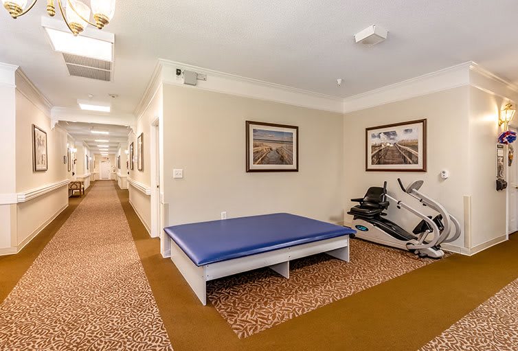 A small gym area with exercise equipment and a stretching mat.