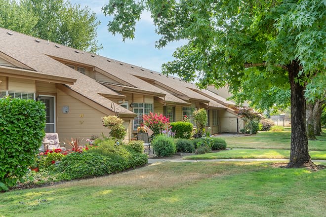 A picturesque residential neighborhood with neatly landscaped lawns and trees.