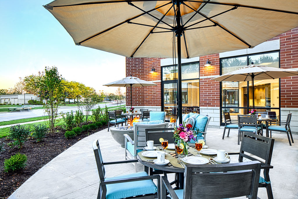A charming outdoor dining area with umbrellas and neatly set tables, perfect for relaxing in a pleasant atmosphere.