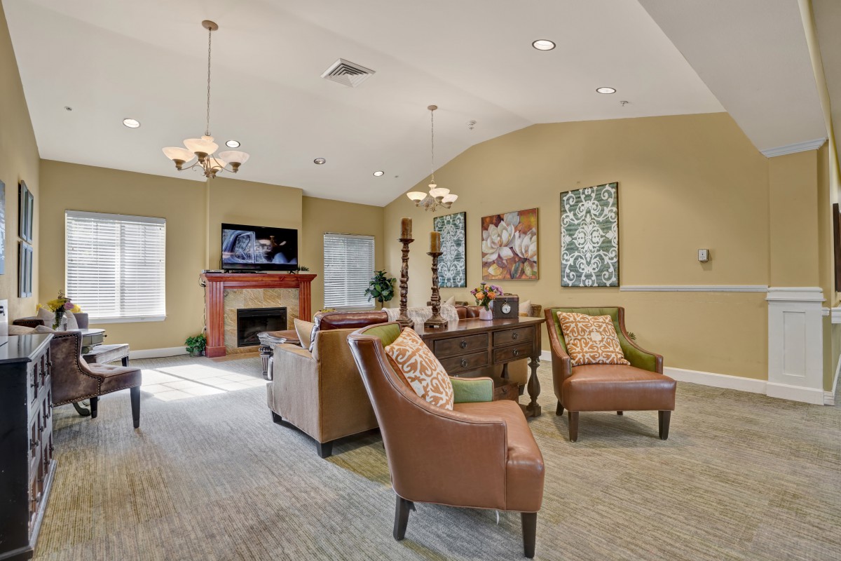 A cozy living room with comfortable seating, a fireplace, and decorative wall art.