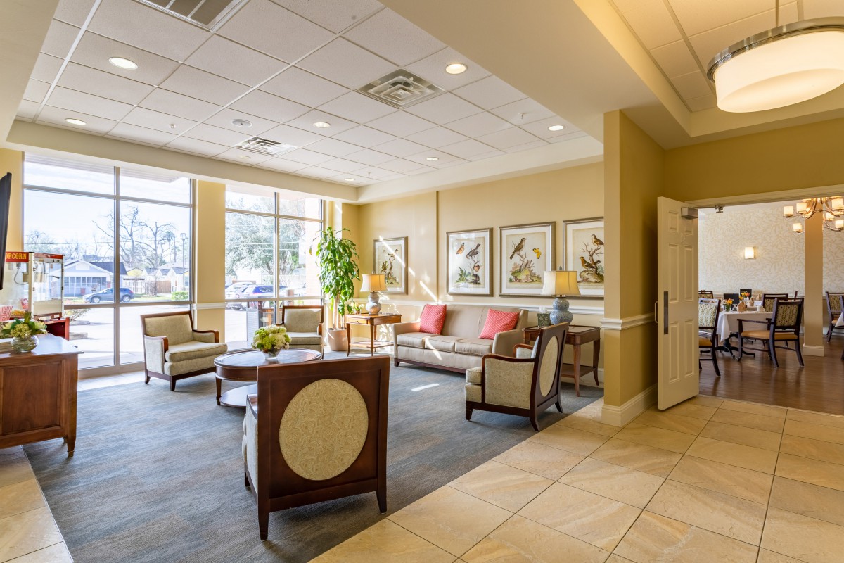 A well-lit lobby area with comfortable seating and decorative artwork on the walls.