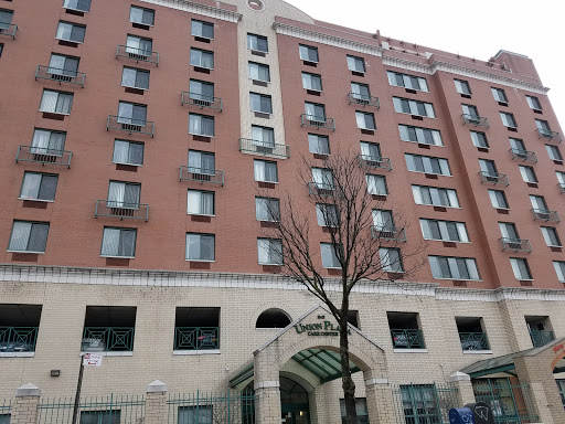 A multi-story hotel building featuring multiple windows and a welcoming entrance.