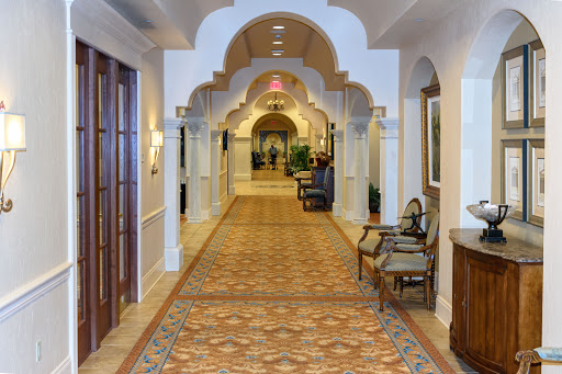 A beautifully designed hallway featuring elegant arches and patterned flooring, leading to a welcoming space.