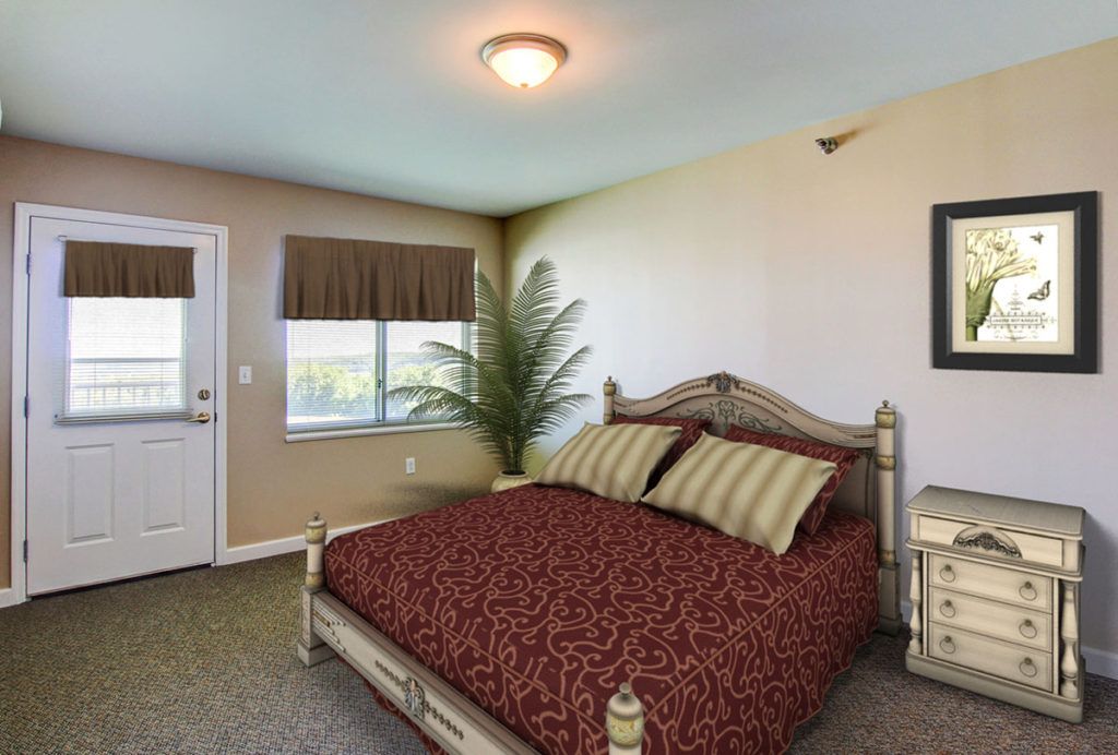 A well-decorated bedroom featuring a large bed with patterned bedding, a window with blinds, and a small indoor plant.