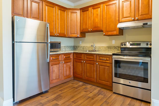 Modern kitchen with wooden cabinets and stainless steel appliances.