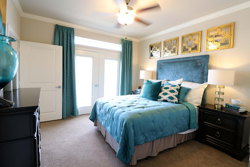 A serene and stylish bedroom featuring a blue theme with modern decor.