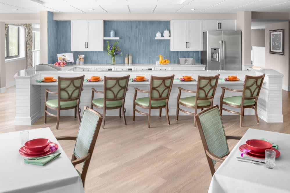 A modern kitchen and dining area with stylish chairs and elegant table settings.
