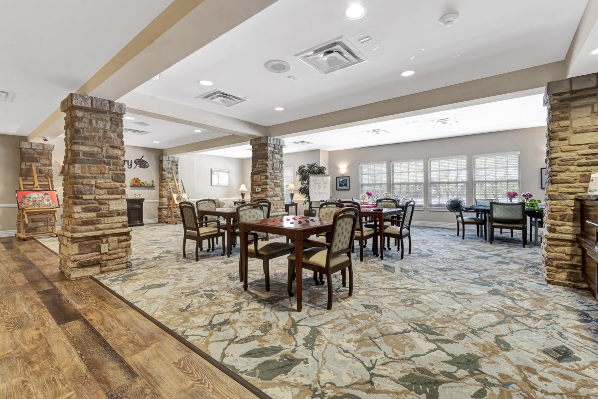 A spacious dining room with elegant tables and chairs, featuring a stylish interior design.