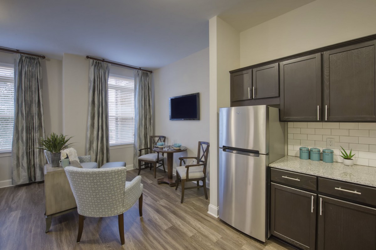 A modern apartment interior with a compact living and kitchen area.