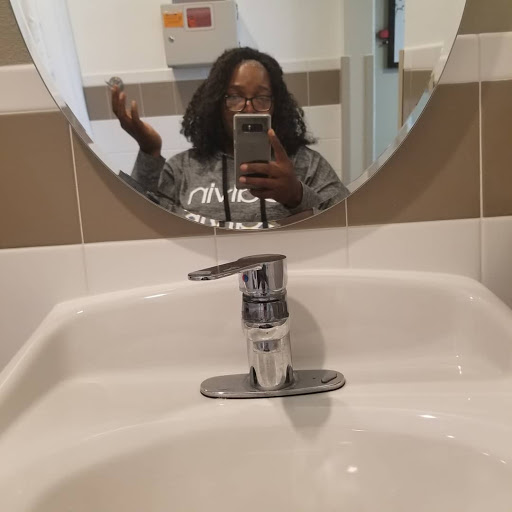 A casual moment captured in the bathroom mirror.
