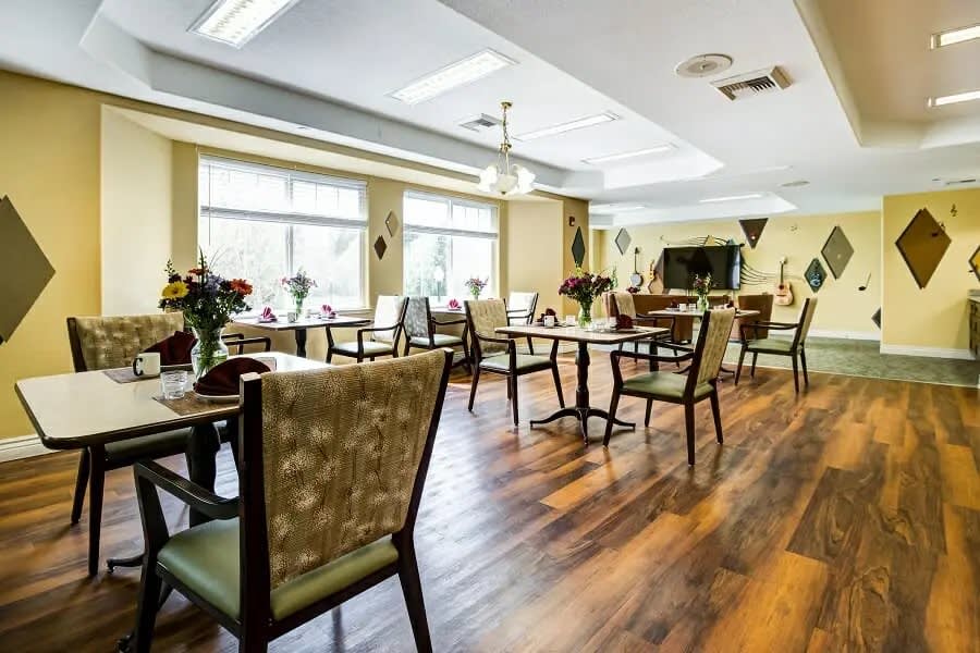 A bright and elegant dining area with neatly arranged tables and chairs.