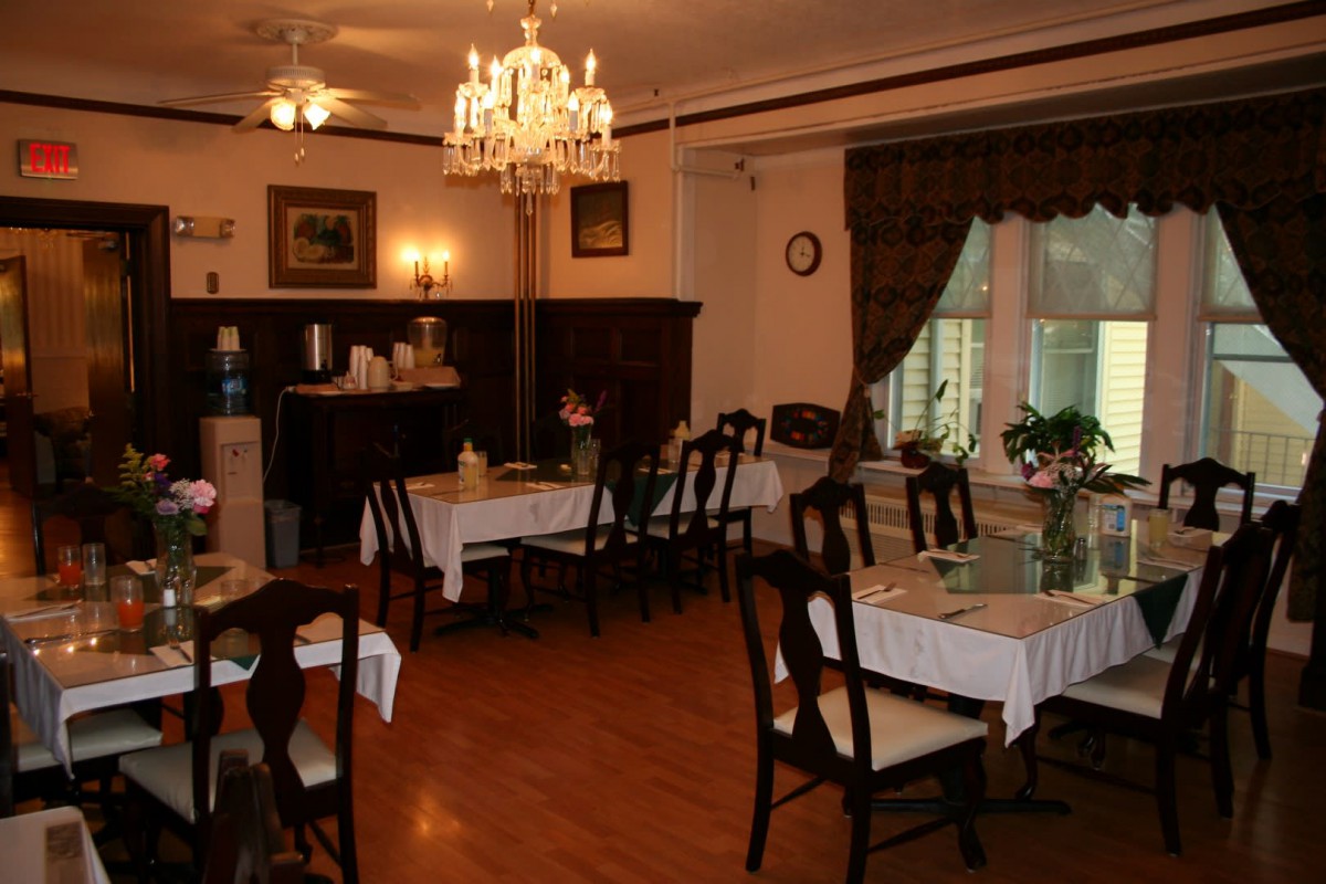A cozy dining room with elegant furnishings and warm lighting.