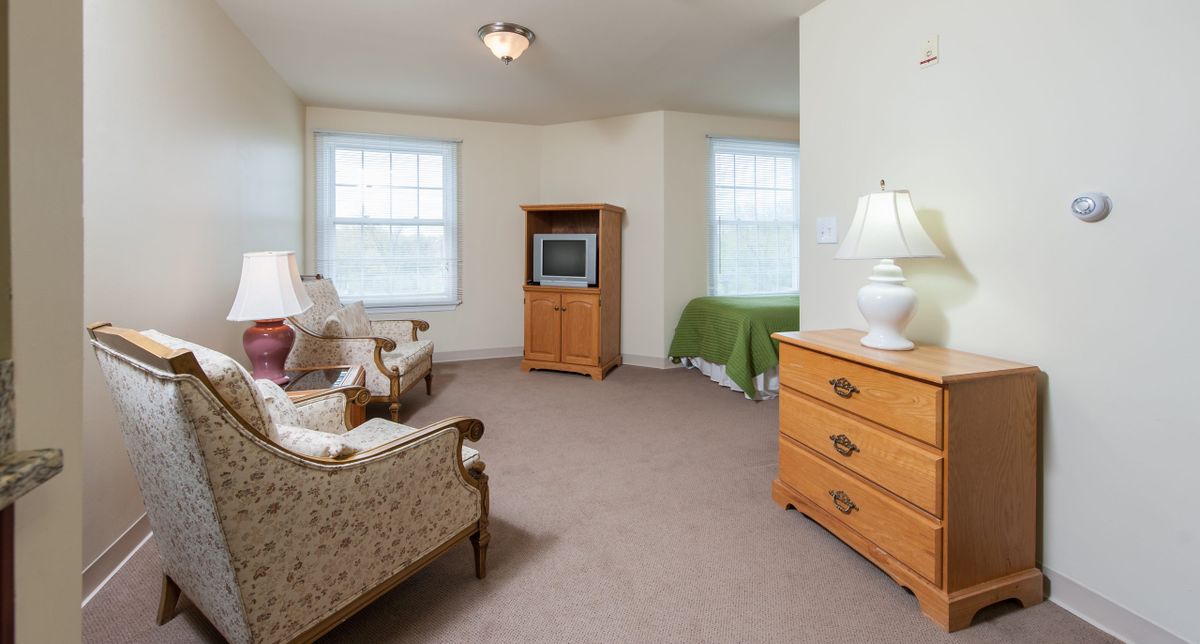 A cozy living space featuring vintage furniture and a classic television.