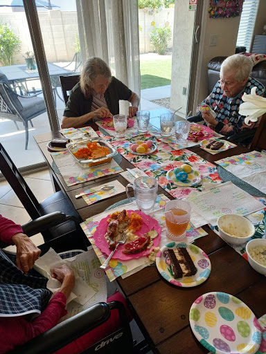 A delightful social gathering with friends, enjoying a variety of colorful snacks and meals at the dining table.