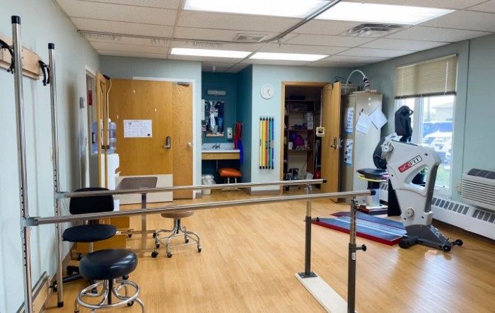 A physical therapy room equipped with exercise and rehabilitation equipment.