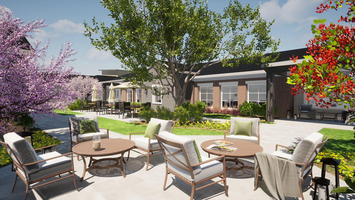 A beautifully landscaped outdoor seating area with comfortable patio furniture under a clear sky.