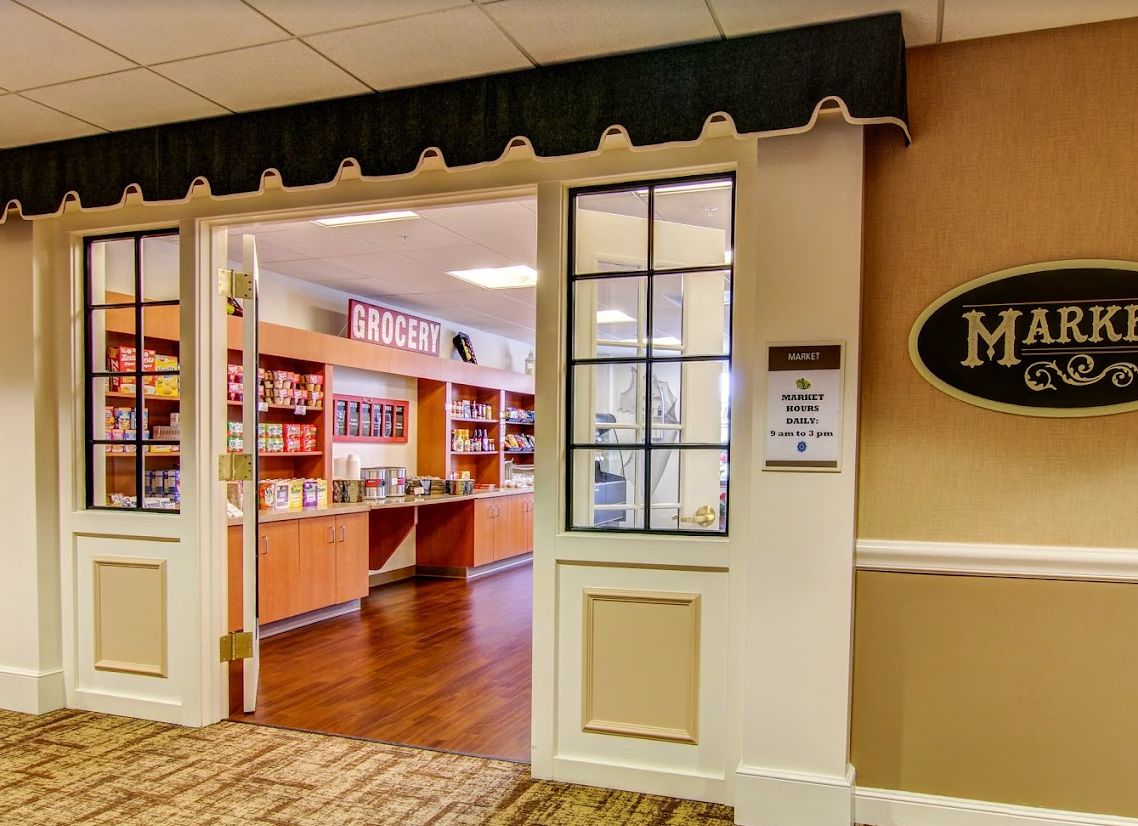 Interior view of a pharmacy with shelves stocked with products.