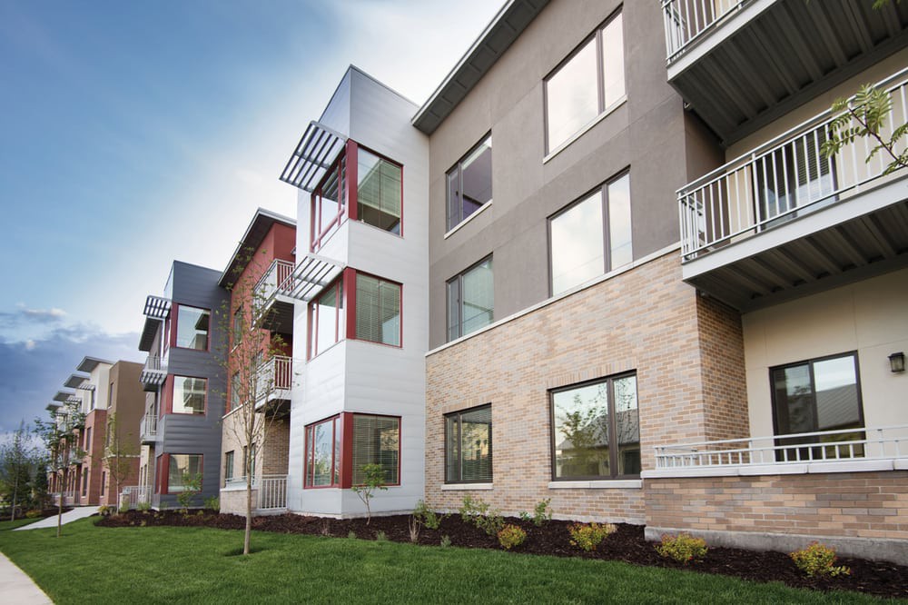 A modern apartment building with landscaped surroundings.