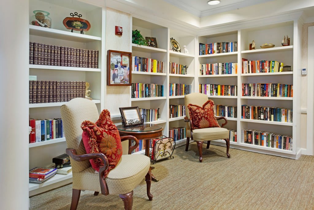 A cozy reading area with bookshelves and comfortable chairs.