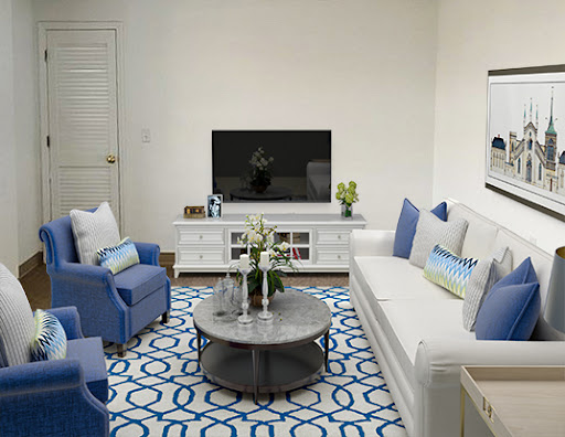A stylish modern living room featuring a blue and white color scheme with comfortable seating and contemporary decor.