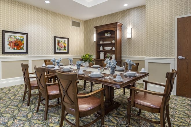 A well-appointed dining room with a set table and classic furnishings.