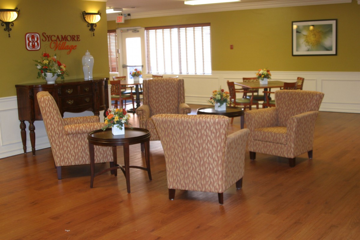 A cozy lounge area with comfortable chairs and small tables.