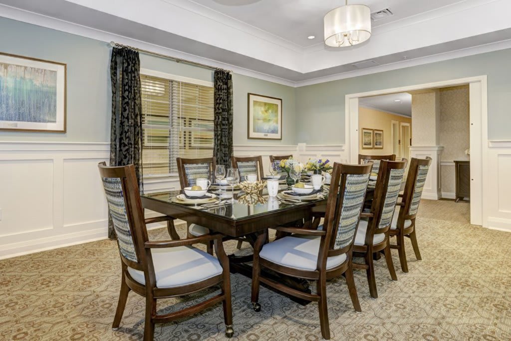 A well-appointed dining room with a large table and elegant chairs.