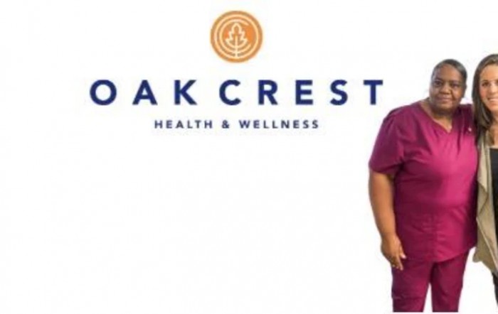 Oak Crest Health & Wellness logo with a person in medical scrubs.