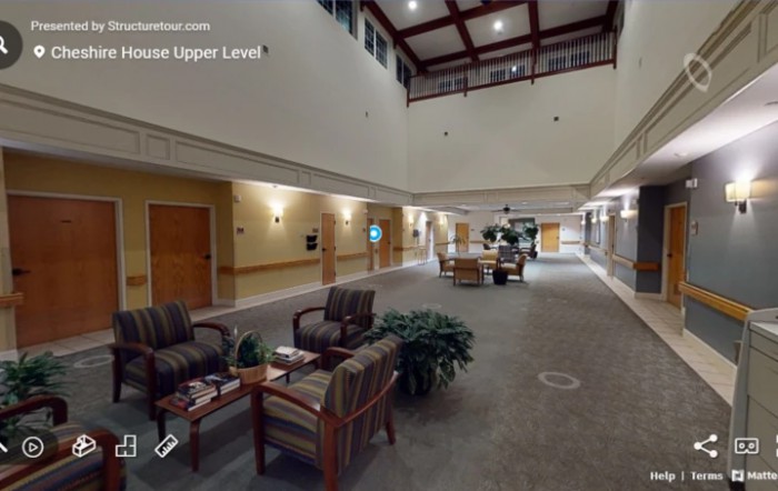 A spacious indoor lobby area with comfortable seating and decorative plants.