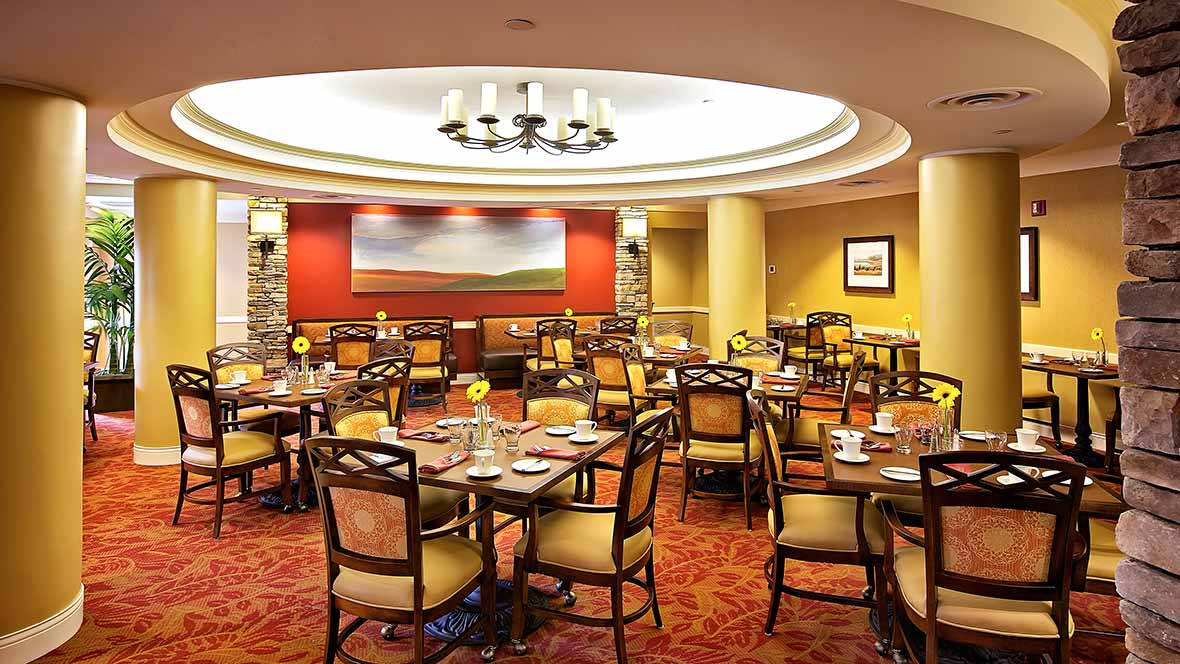 A well-decorated restaurant interior with arranged tables and chairs.