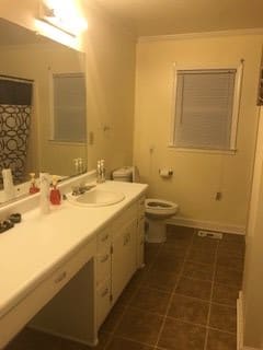 A clean bathroom with a large mirror above the sink and a window next to the toilet.