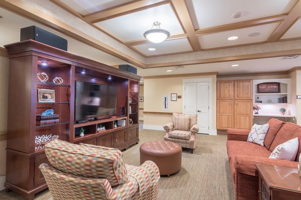 A cozy living room with comfortable seating and a large television.