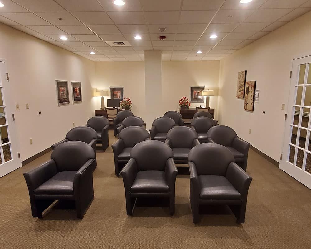 An empty waiting room with arranged seating and soft lighting.