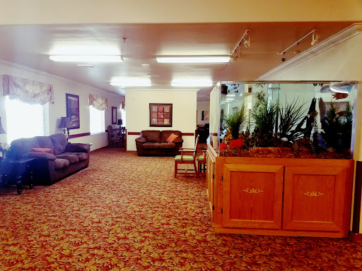 A spacious and inviting lounge area featuring comfortable sofas and an aquarium.