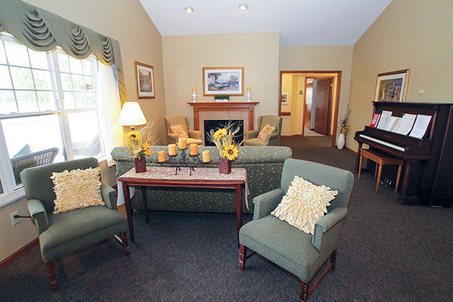A cozy living room with comfortable seating, a fireplace, and decorative elements creating a warm and inviting atmosphere.
