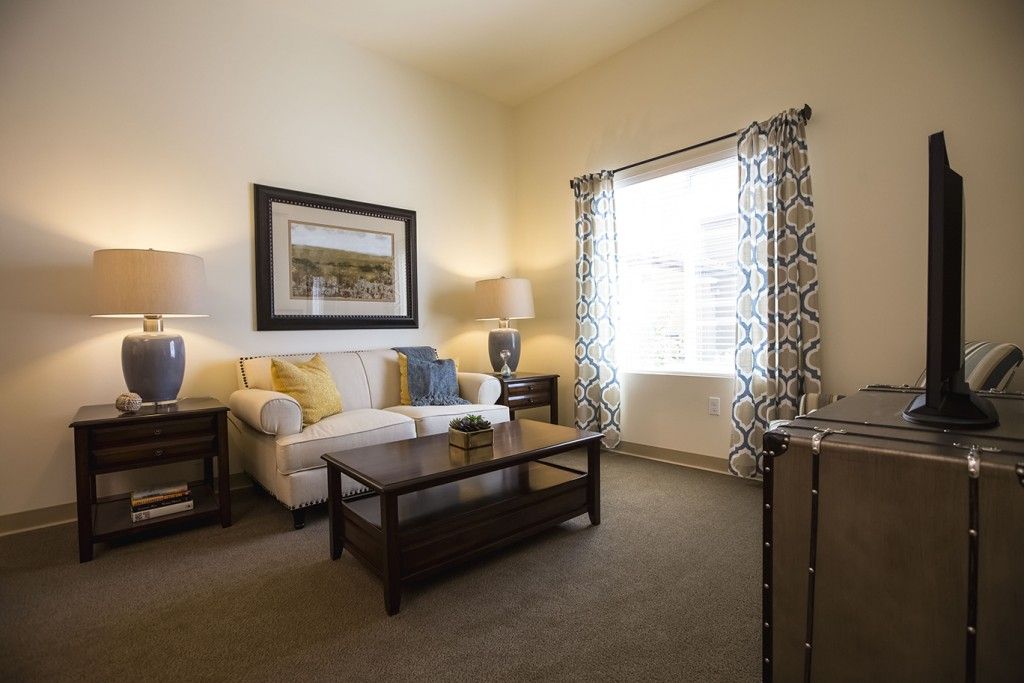 A cozy living room with a sofa, coffee table, and elegant decor.